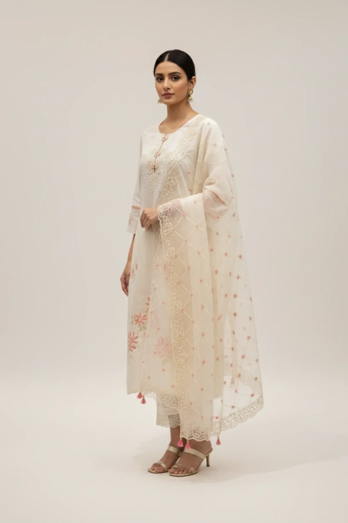Off white Chanderi suit with delicate floral embroidery, paired with matching pants and an embroidered dupatta — perfect for festive and elegant occasions.