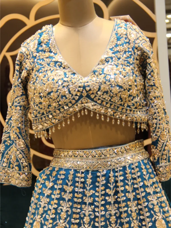 Royal Blue designer net lehenga embellished with beads and crystals, paired with matching blouse and dupatta – perfect for weddings and festive occasions.