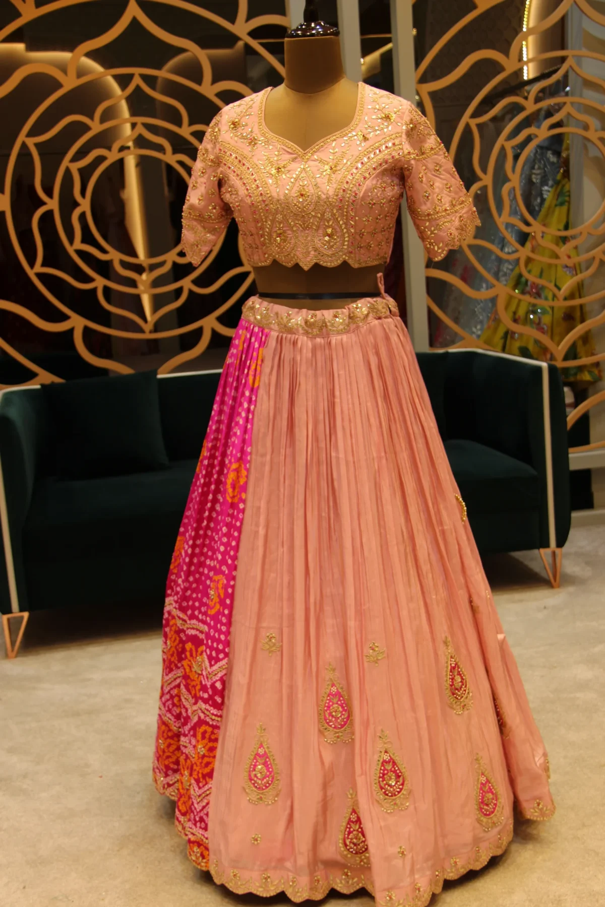 Pink satin silk designer lehenga embellished with Gota Patti embroidery and Bandhani patchwork on one side, paired with matching blouse and dupatta — ideal for sangeet and festive occasions.