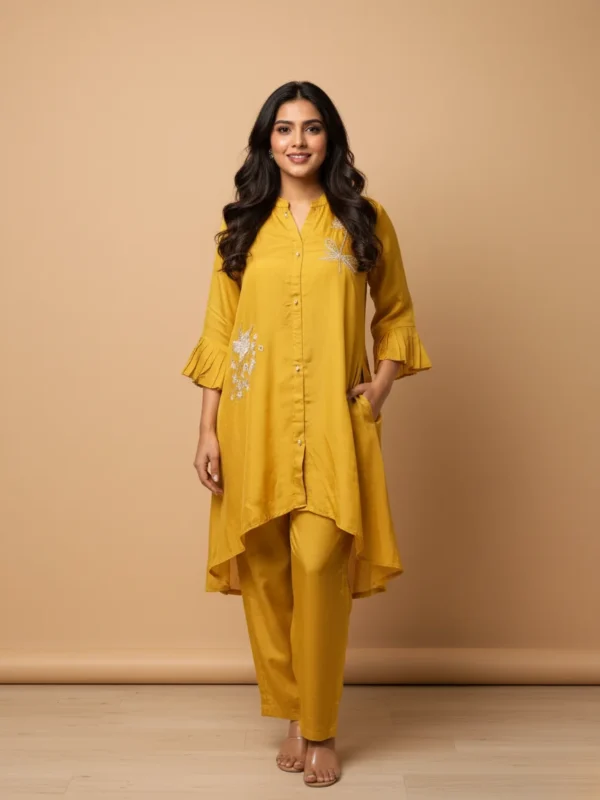 Model wearing Rangoli Sari’s yellow aurganza co-ord set with crystal embellishment, pleated sleeves, and relaxed fit – festive ethnic wear for women.