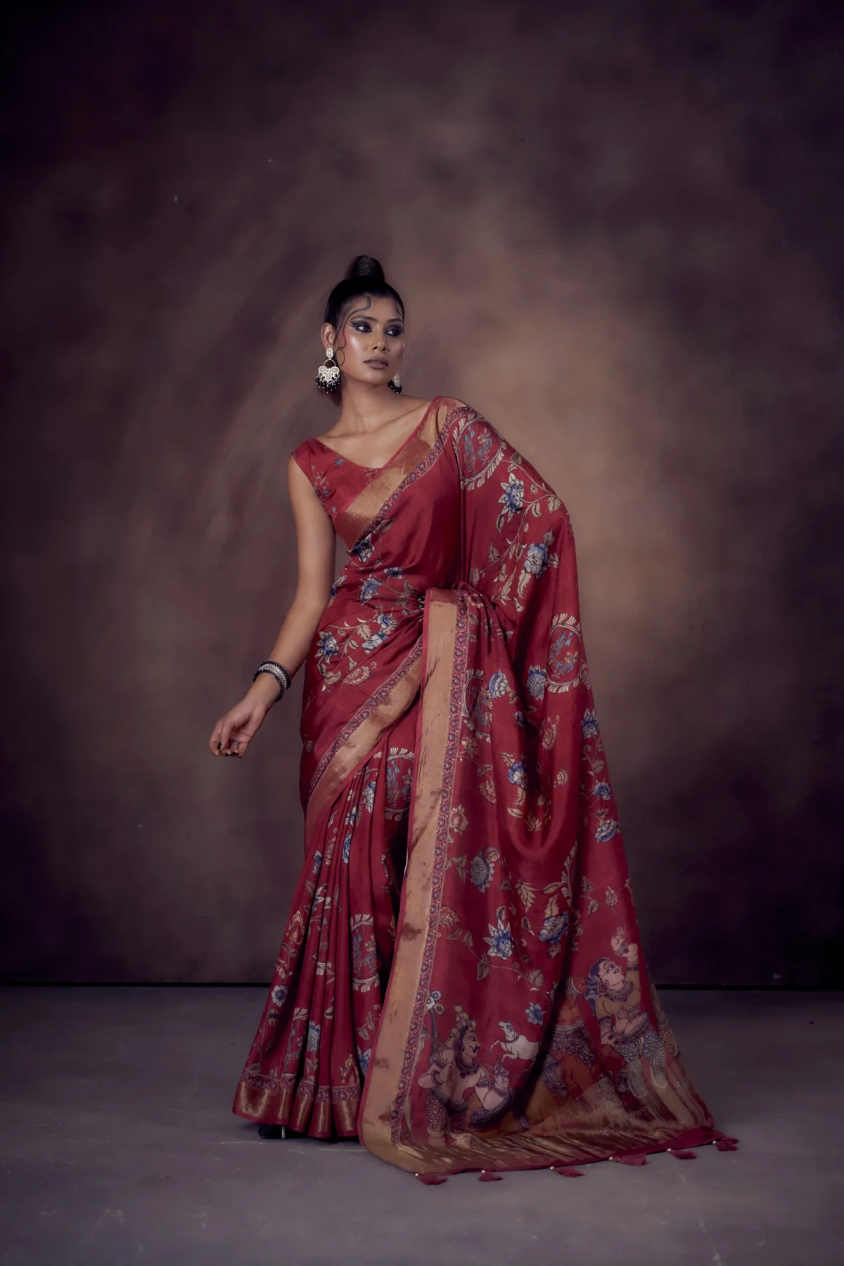 Ruby Moonga Tussar saree with Kalamkari and Pichwai prints featuring woven zari border