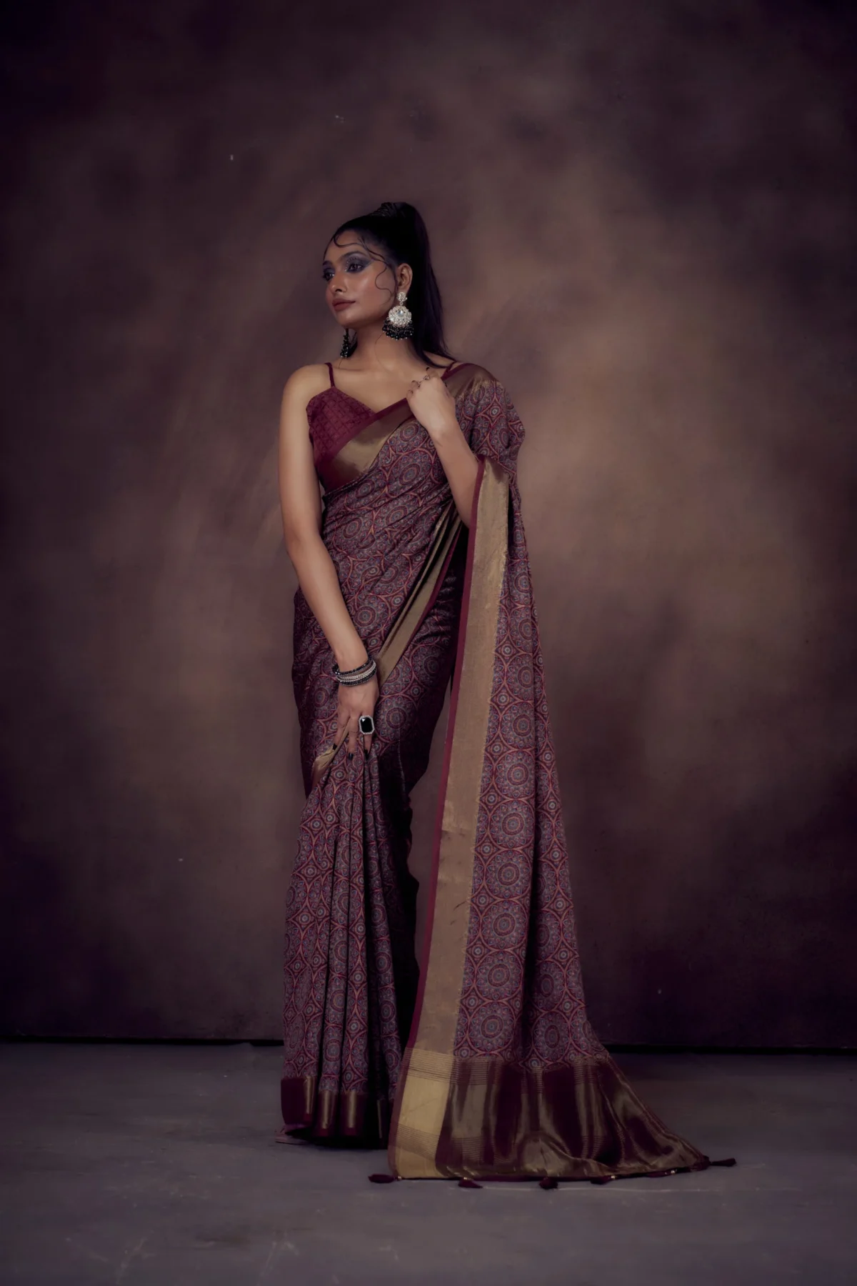 Maroon Mandala print Moonga Tussar saree with golden zari border and traditional pallu