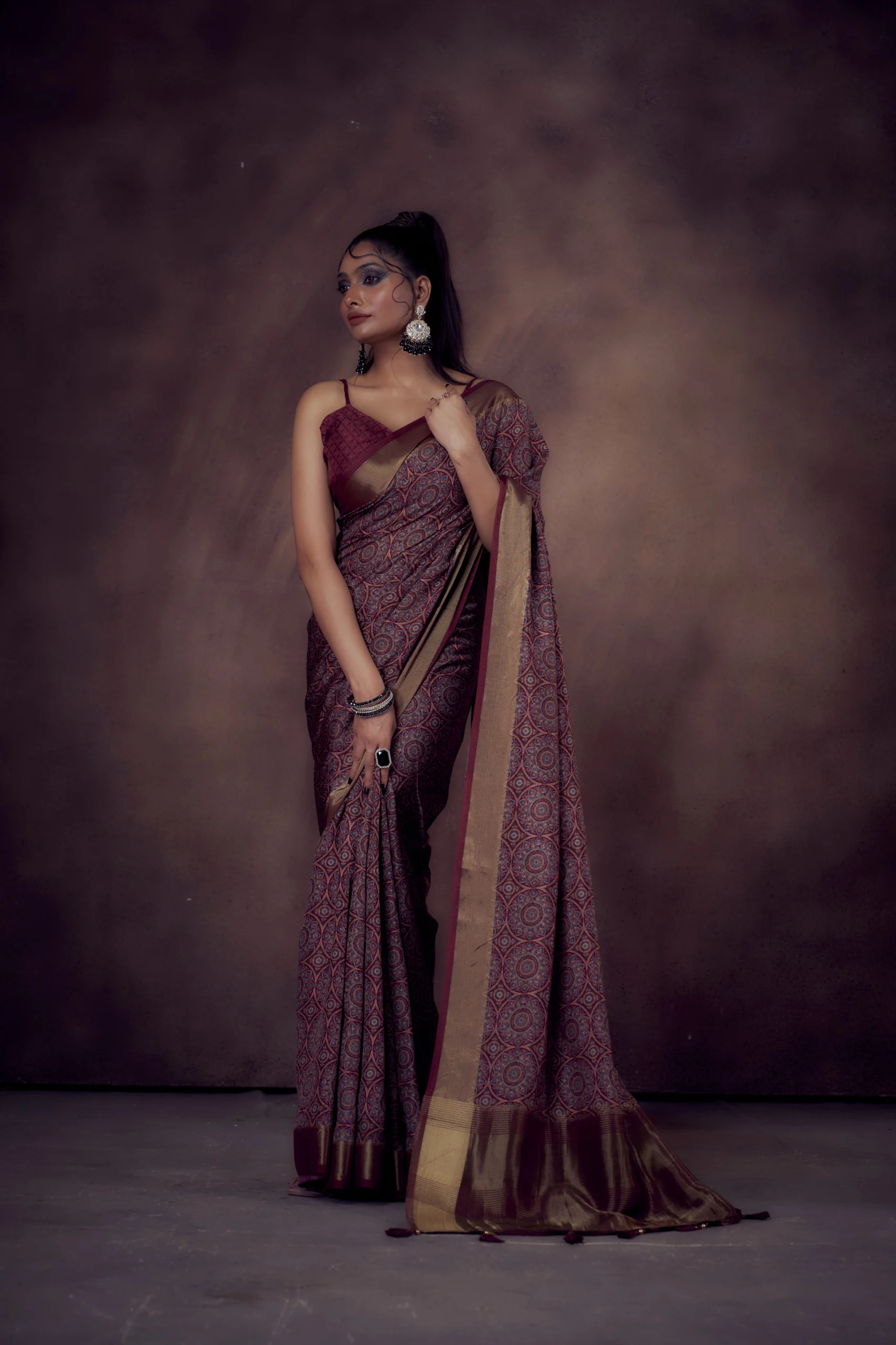Maroon Mandala print Moonga Tussar saree with golden zari border and traditional pallu