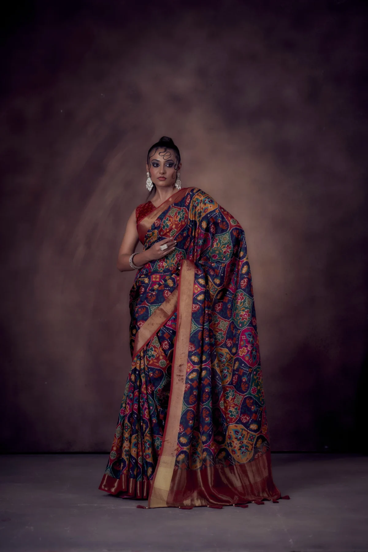 Moonga Tussar saree in jewel-tone Patola print with golden zari border