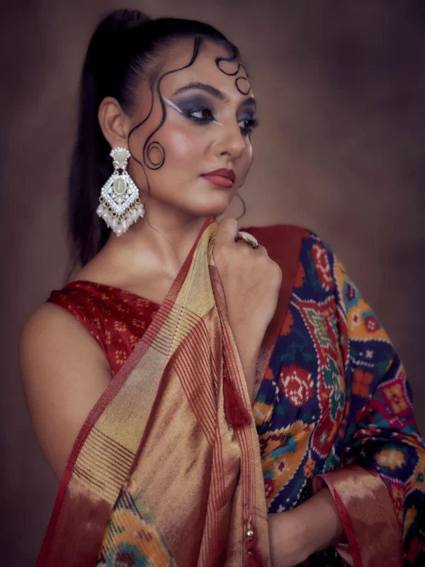 Moonga Tussar saree in jewel-tone Patola print with golden zari border