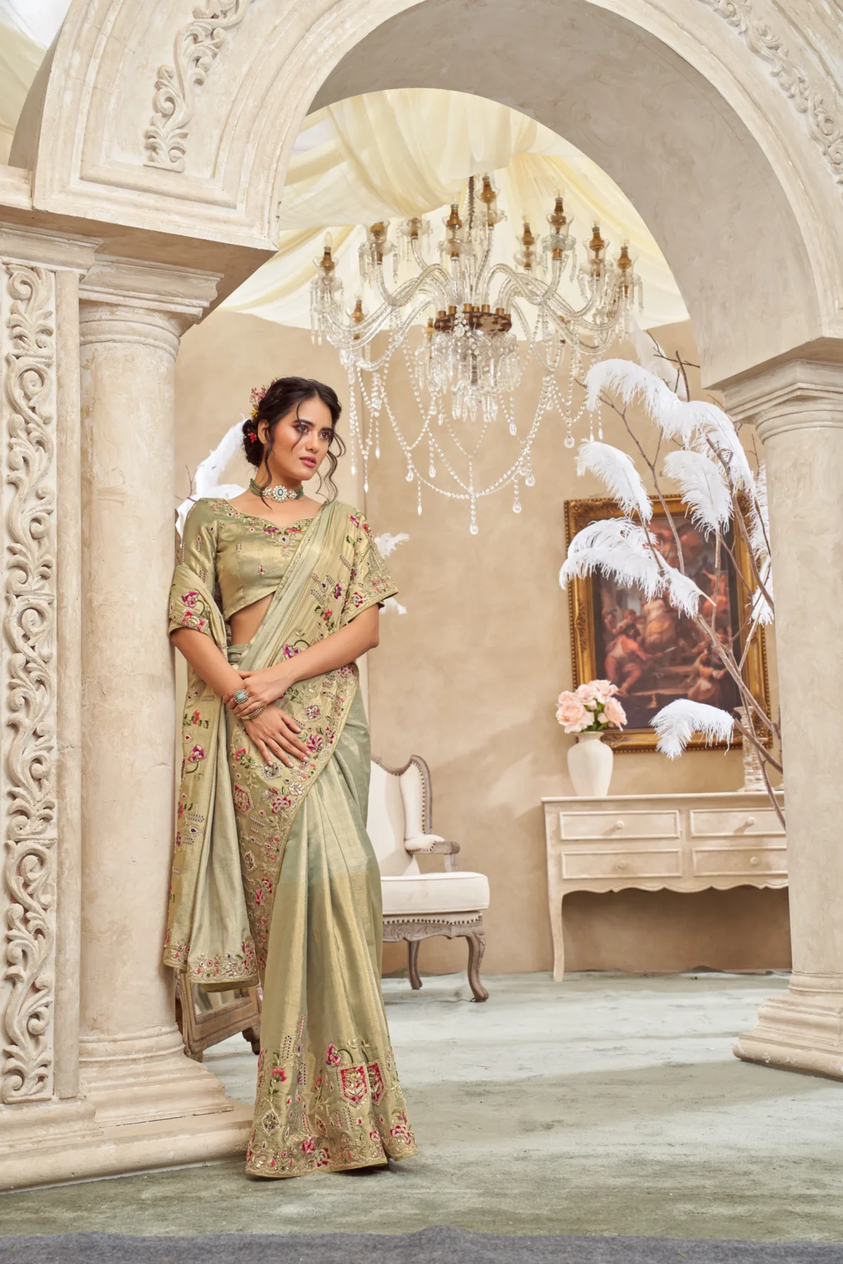 Model wearing an ivory olive designer saree with intricate hand embroidery and unstitched blouse.
