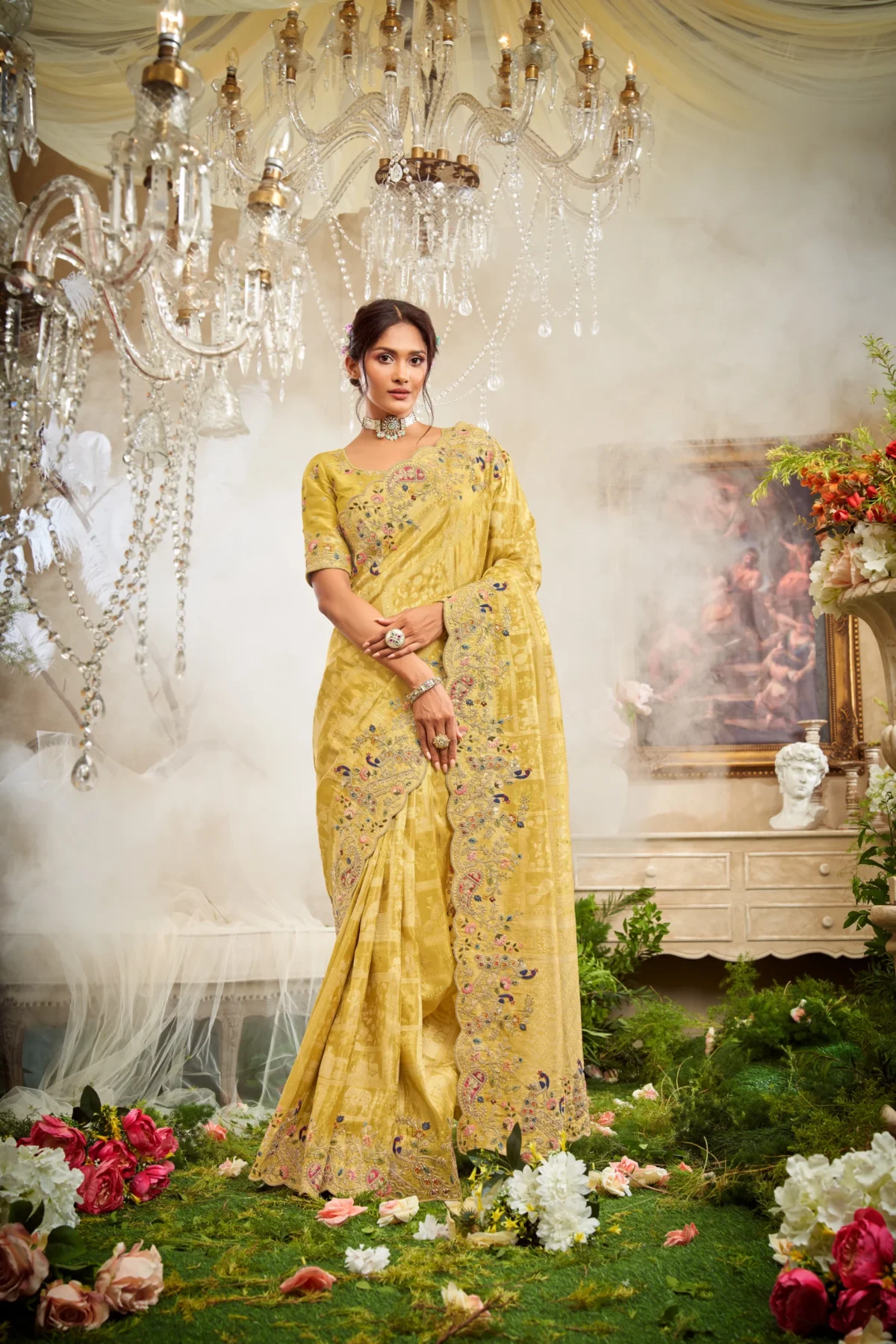 Model wearing a mustard hand-embroidered luxury designer saree with rich detailing and unstitched blouse.