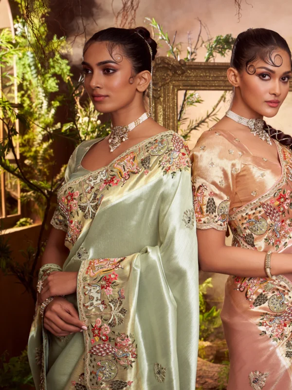 Model wearing a mint-gold designer saree with heavy embroidered border and matching embroidered unstitched blouse.