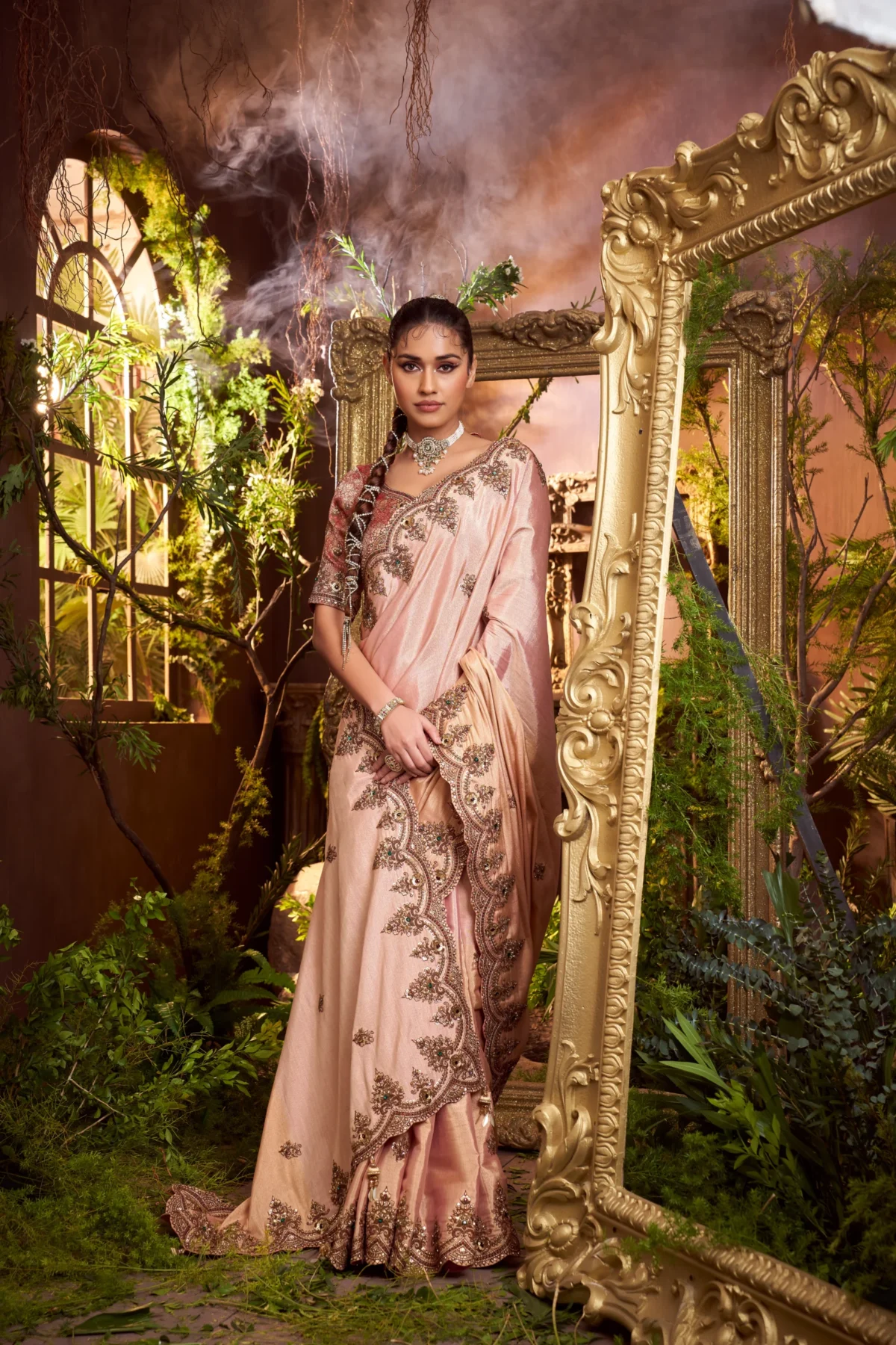 Model wearing a blush pink hand-embroidered designer silk saree with scalloped border and contrast blouse.