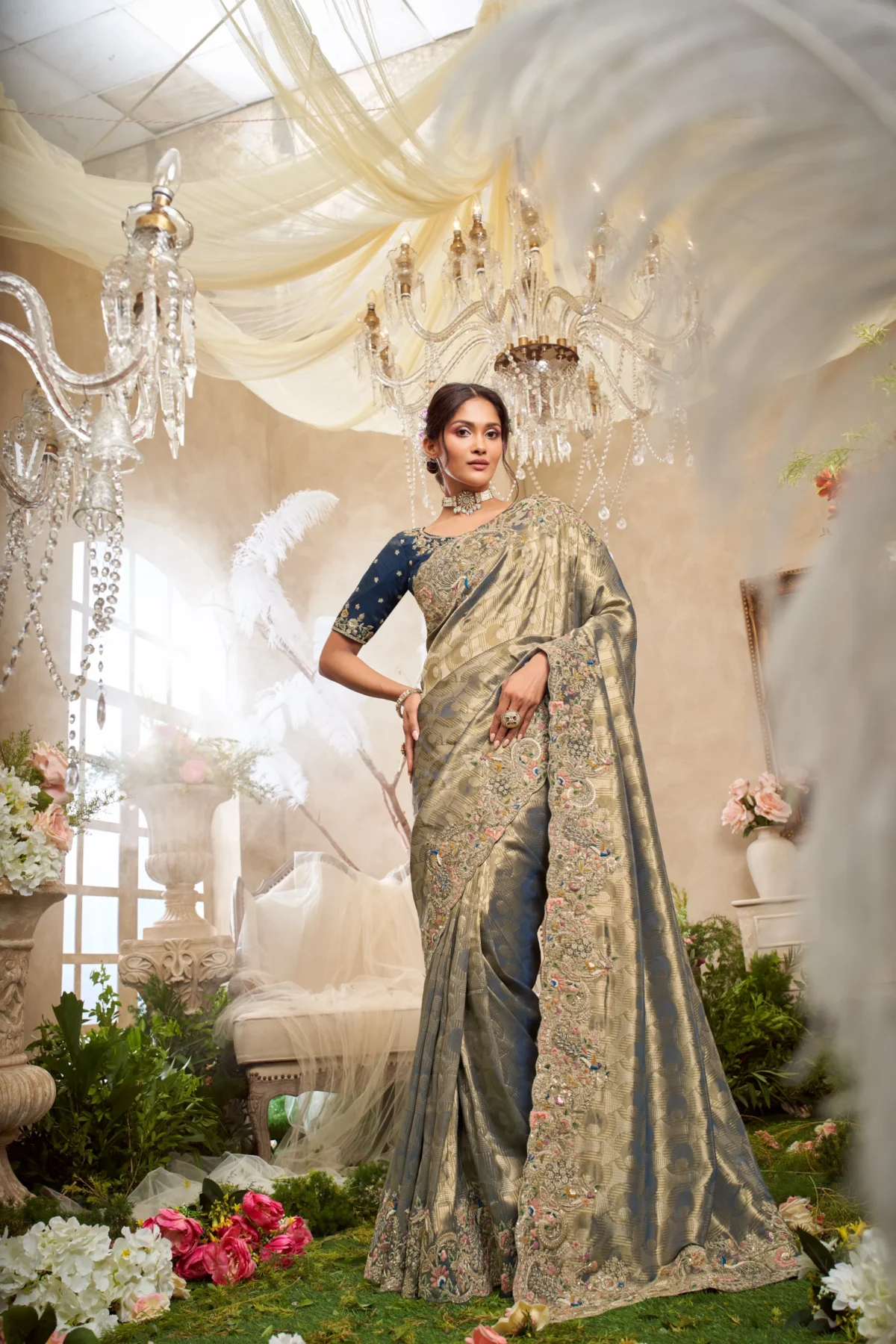 Model wearing a midnight blue and gold hand-embroidered luxury silk saree with embellished border.