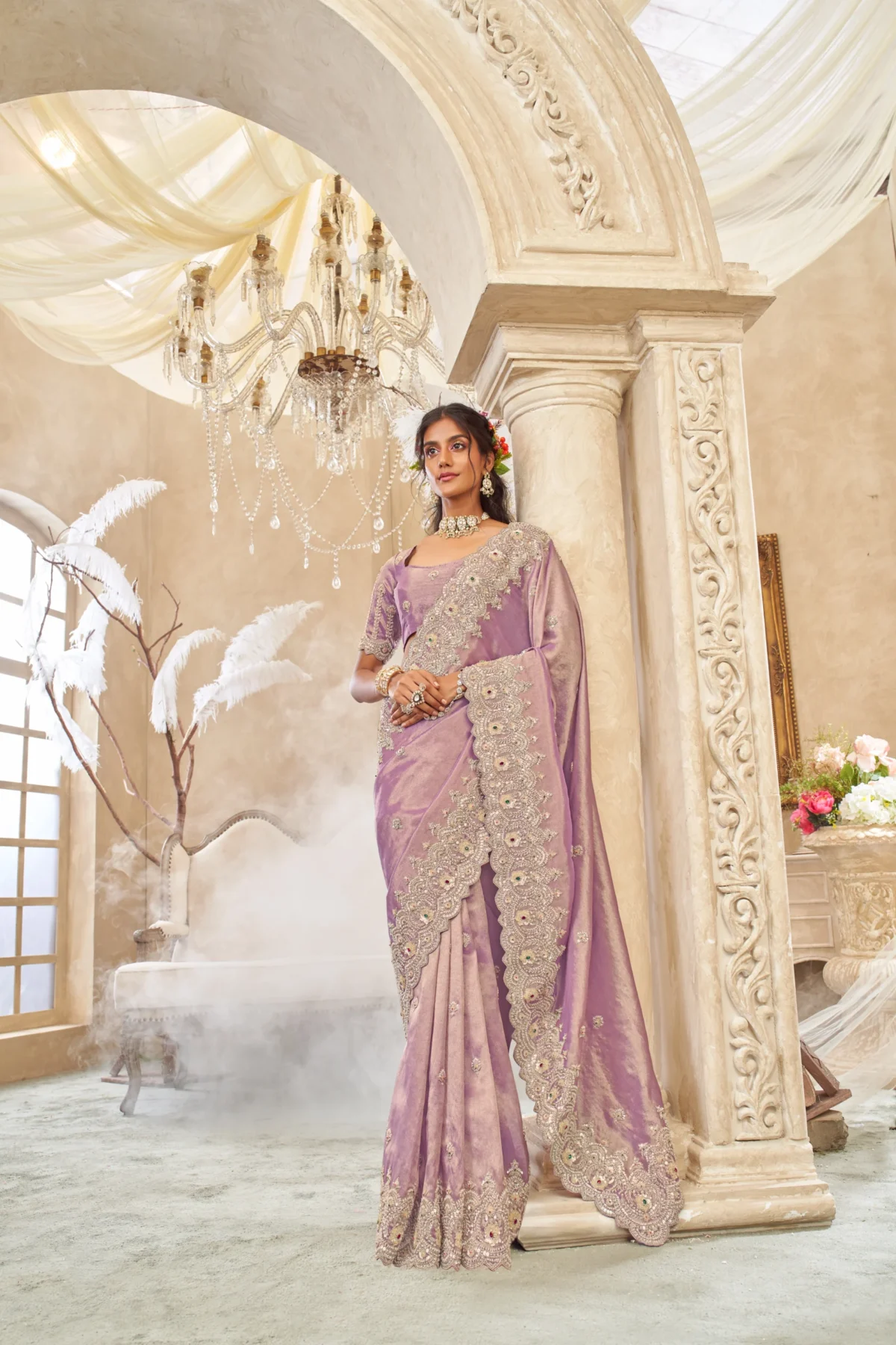 Model wearing a lavender hand-embroidered luxury silk saree with scalloped embellished border