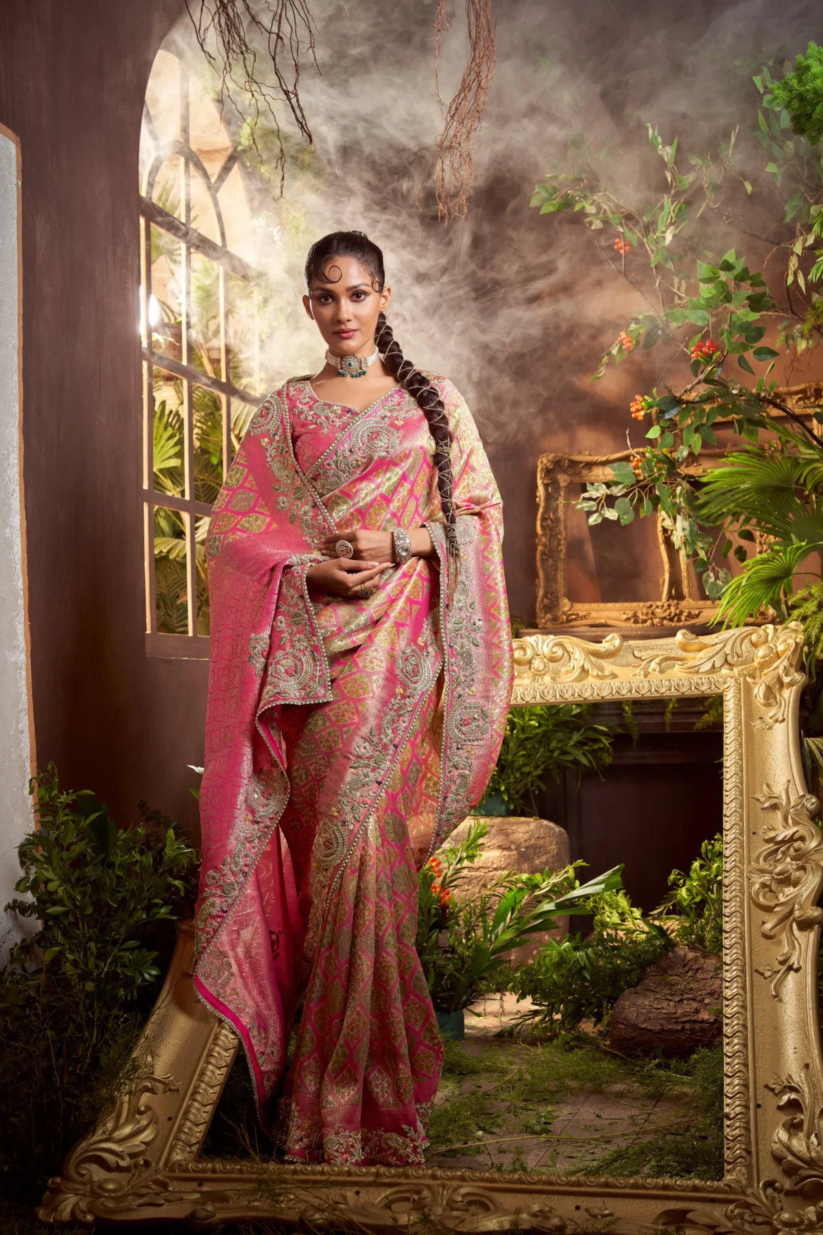 Model wearing fuchsia pink zari embroidered silk saree with scalloped border.