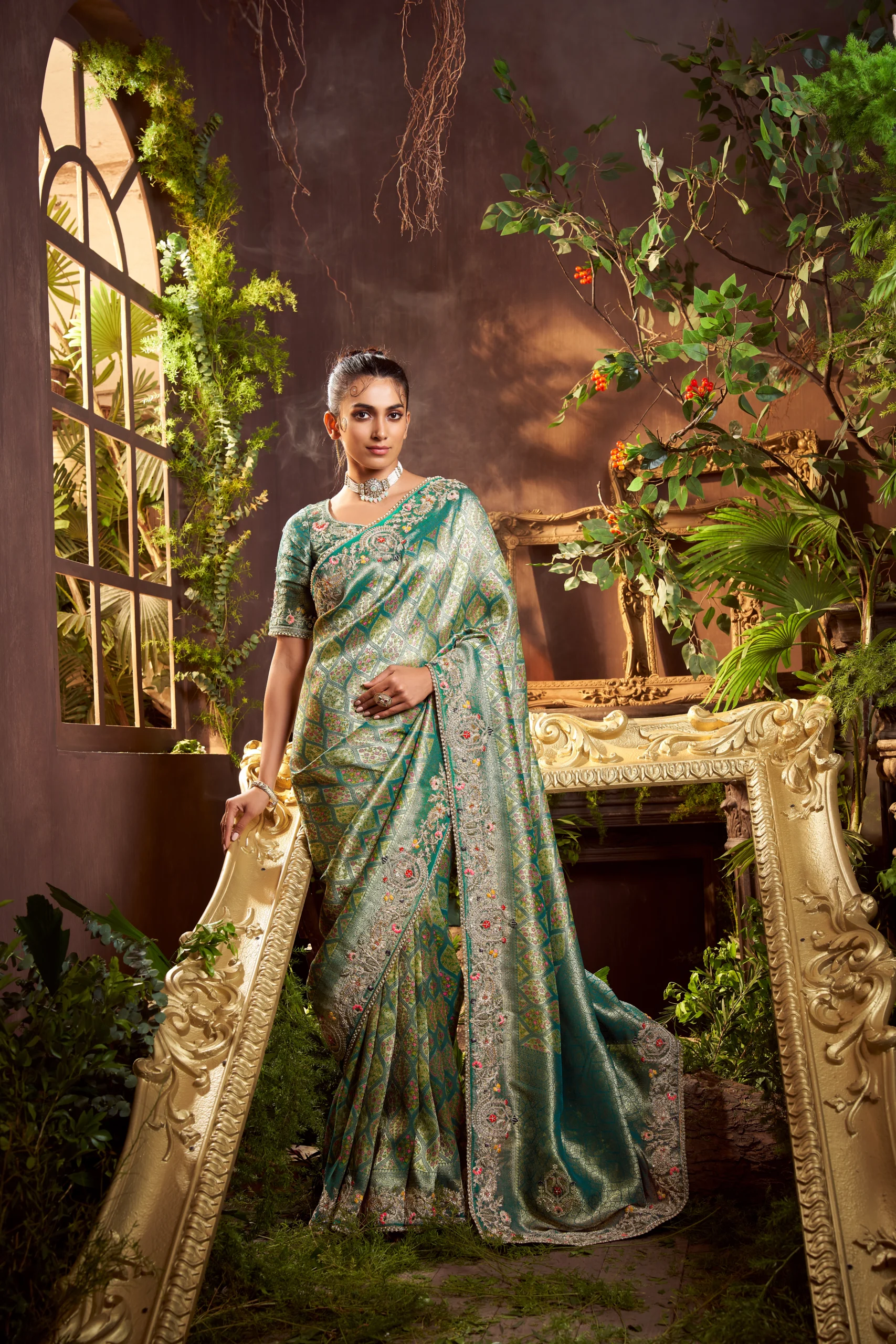 Emerald green hand-embroidered designer saree with zari work and embroidered border