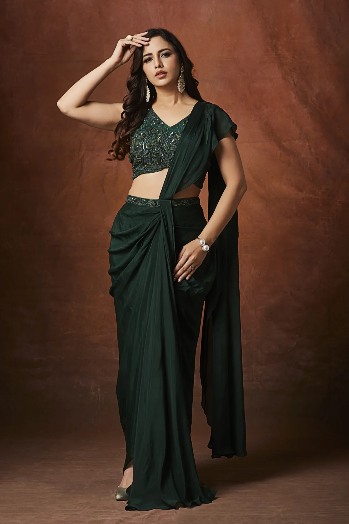 Emerald green designer draped saree with embellished blouse for cocktail wear