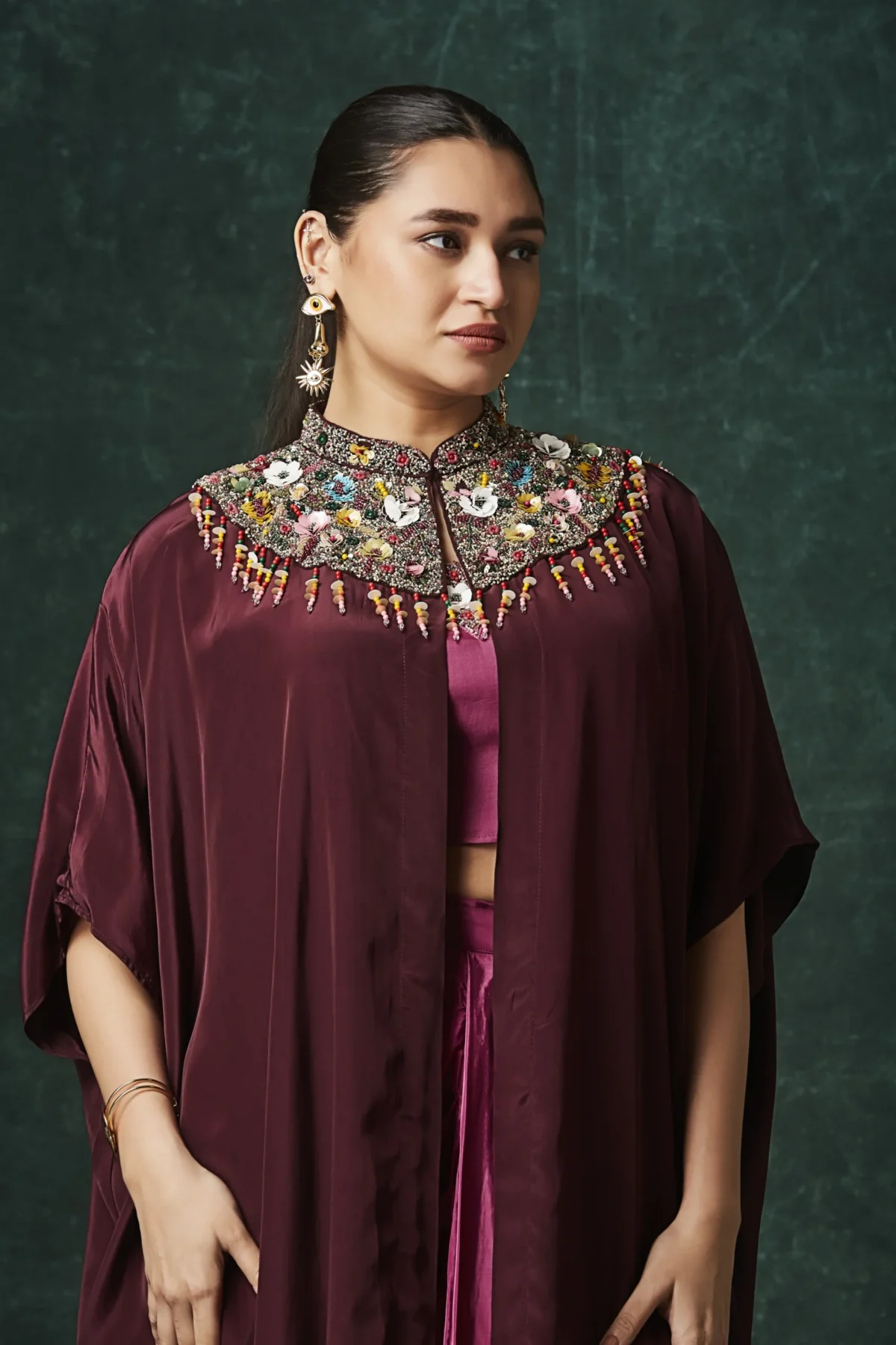 Burgundy draped plazo set with embellished cape for festive and cocktail wear