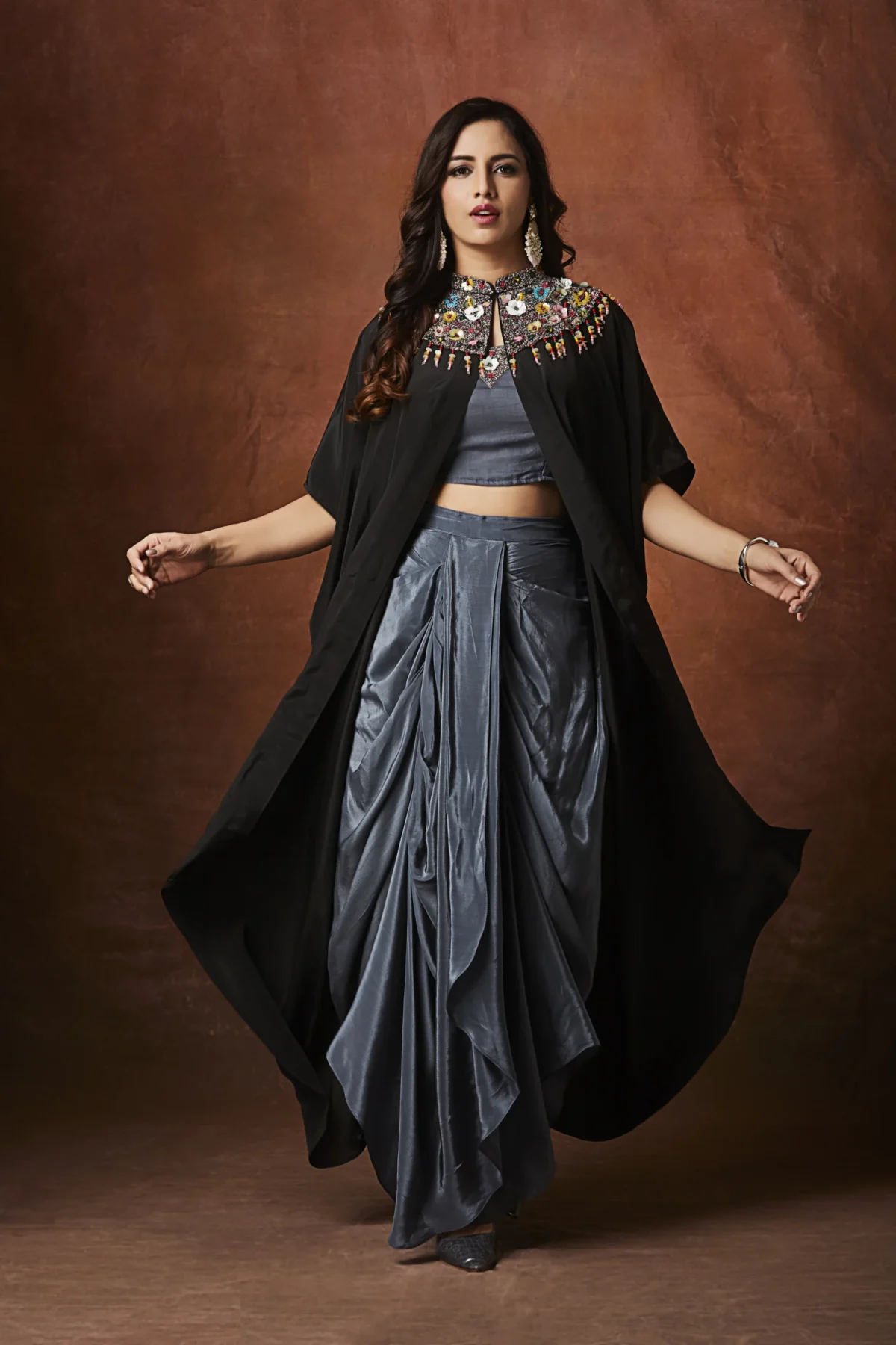 Charcoal grey embellished plazo set with statement black cape jacket for festive wear