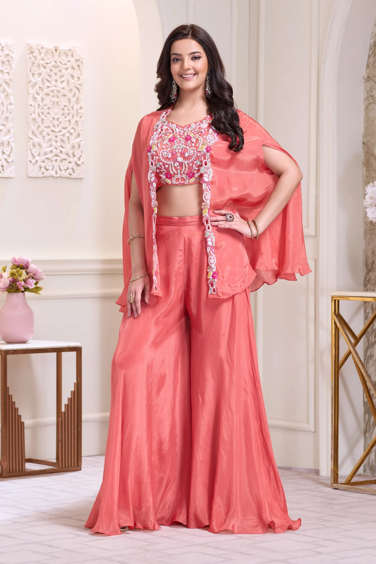 Coral Indo Western cape set with floral embroidered blouse and wide leg palazzo pants for wedding and festive wear.