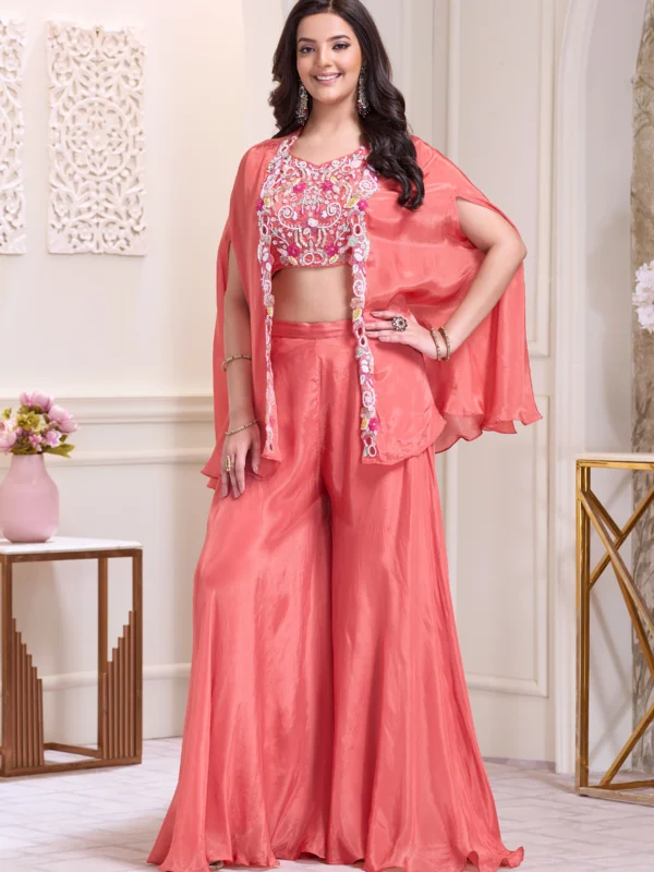 Coral Indo Western cape set with floral embroidered blouse and wide leg palazzo pants for wedding and festive wear.