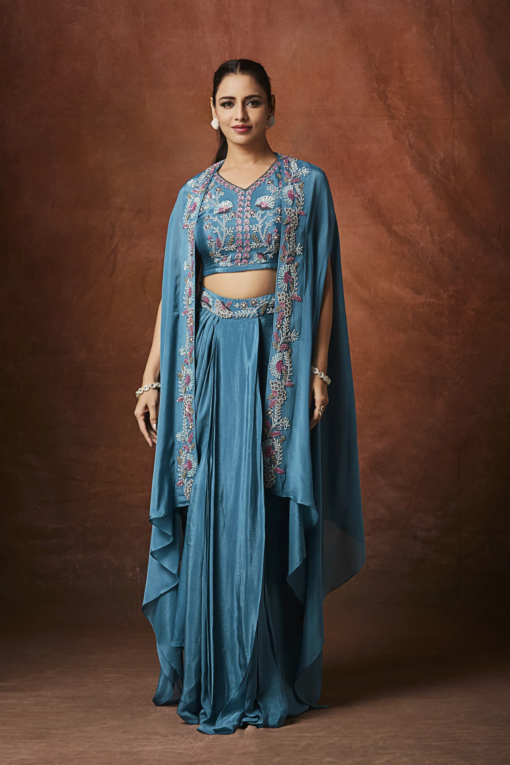Teal blue embellished cape and draped Indo-Western ensemble for festive wear