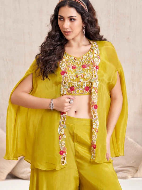 Yellow embroidered blouse with cape overlay and wide flare bottoms Indo-Western festive outfit for women.