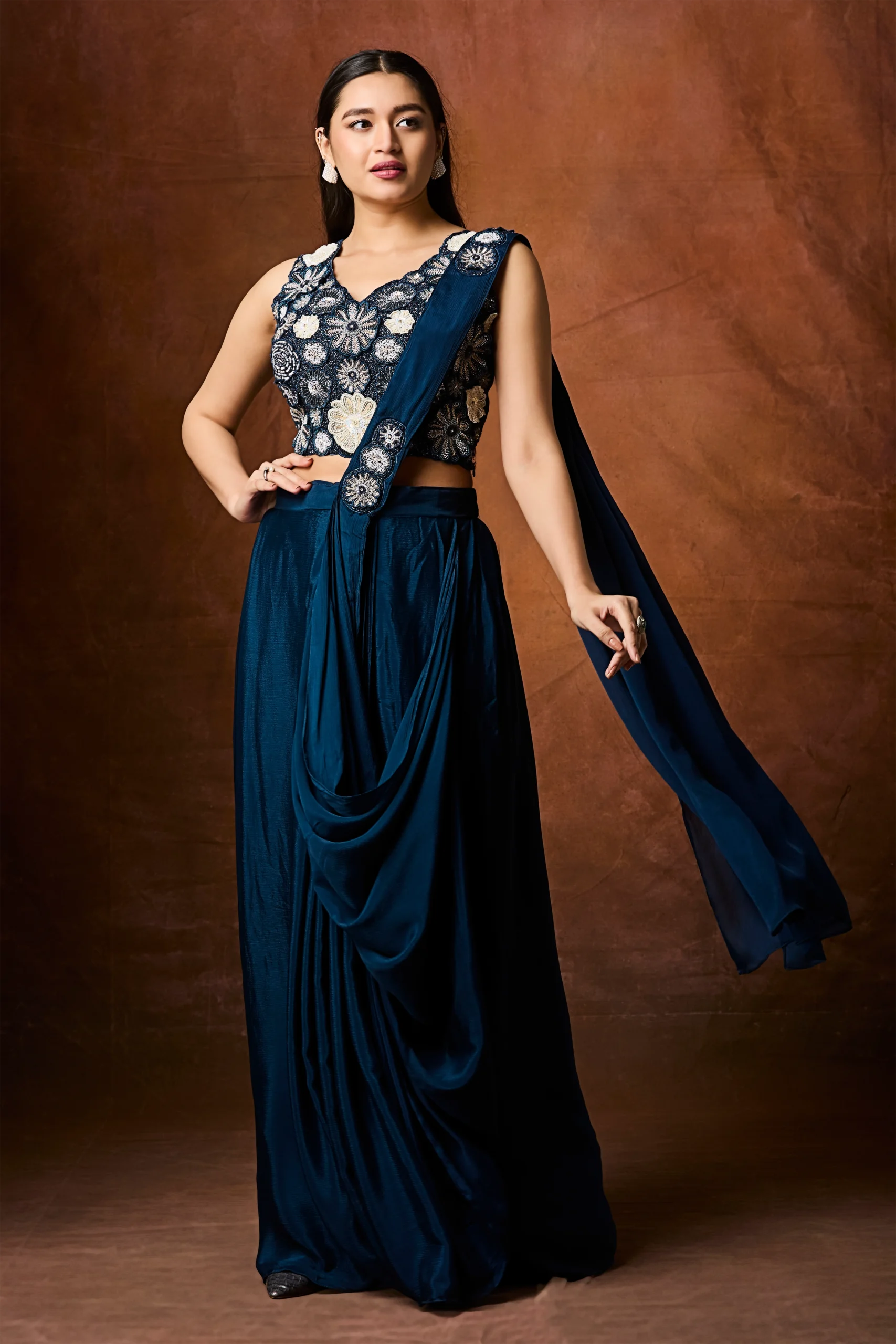 Midnight teal pre draped saree with ivory floral embroidered sleeveless blouse designer cocktail wear.