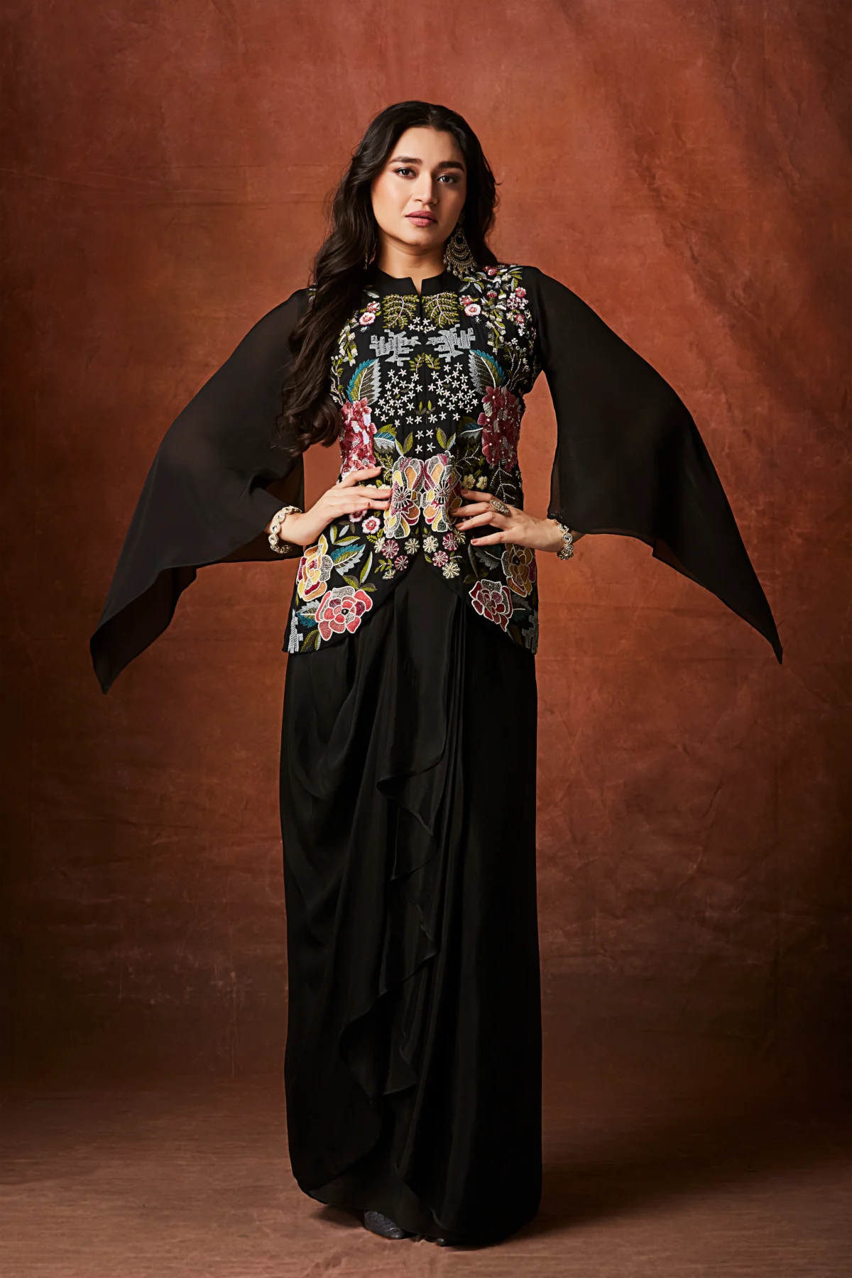 Black Indo Western drape set with multicolour floral embroidered bodice and cape sleeves for reception and cocktail wear.