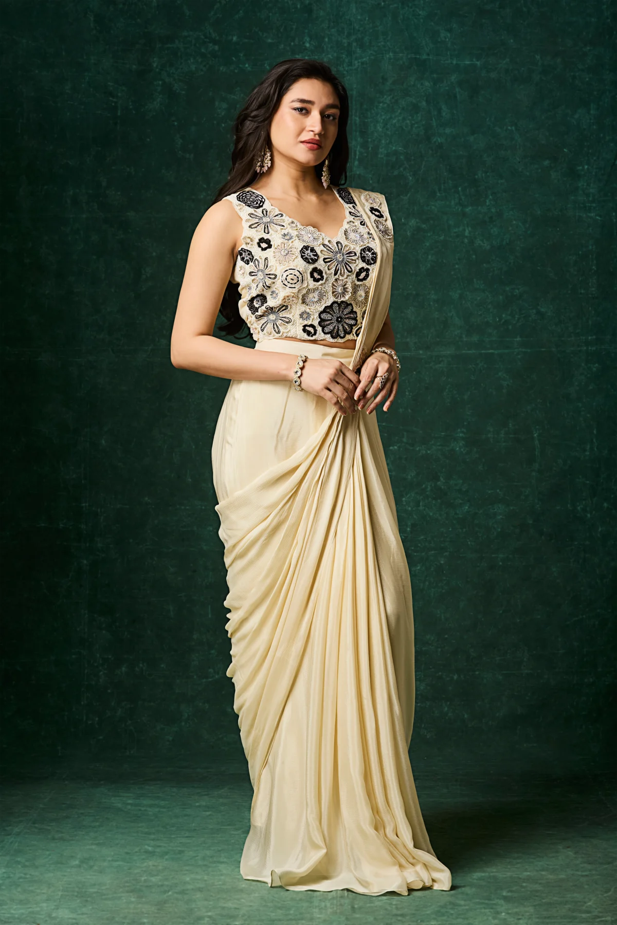 Ivory pre draped saree with black floral embroidered sleeveless blouse designer cocktail saree.