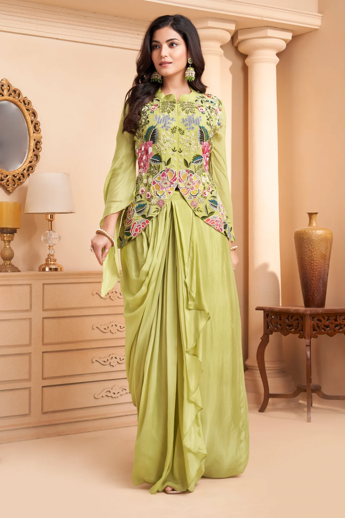 Pistachio green Indo Western drape set with floral embroidery, peplum bodice and cape sleeves for wedding and festive wear.