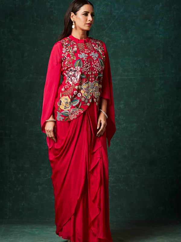 Crimson red Indo Western drape set with floral embroidered bodice and cape sleeves for reception and cocktail wear.