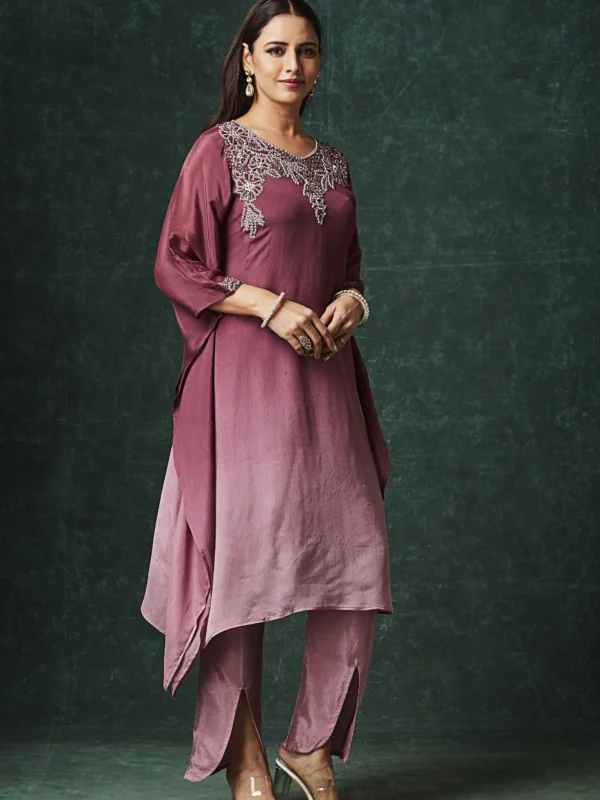 Mauve Indo Western kurta set with embellished neckline, cape sleeves and slit pants for festive wear.