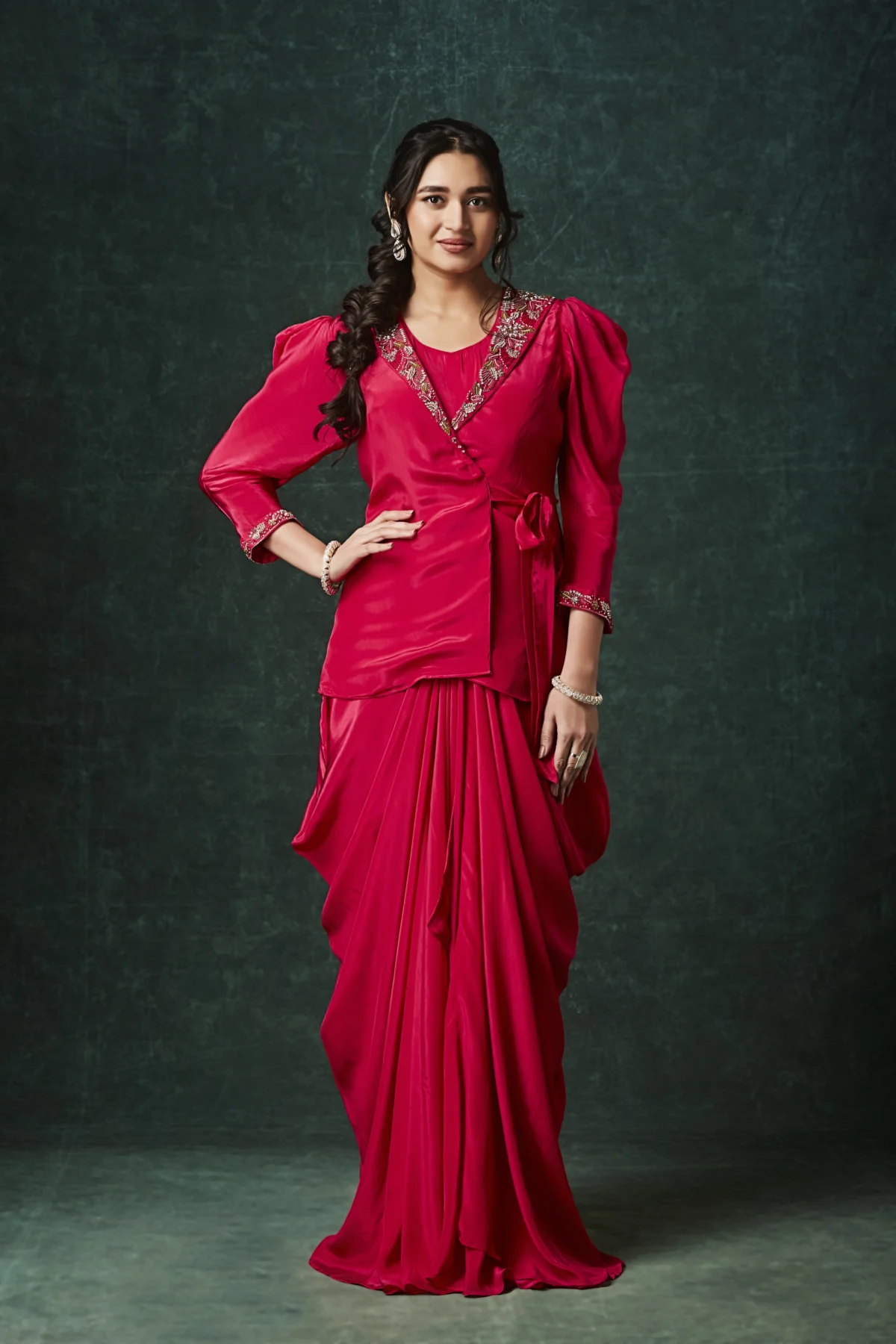 Purple draped Indo Western outfit with embellished wrap blouse and pleated flowing skirt for wedding reception wear.