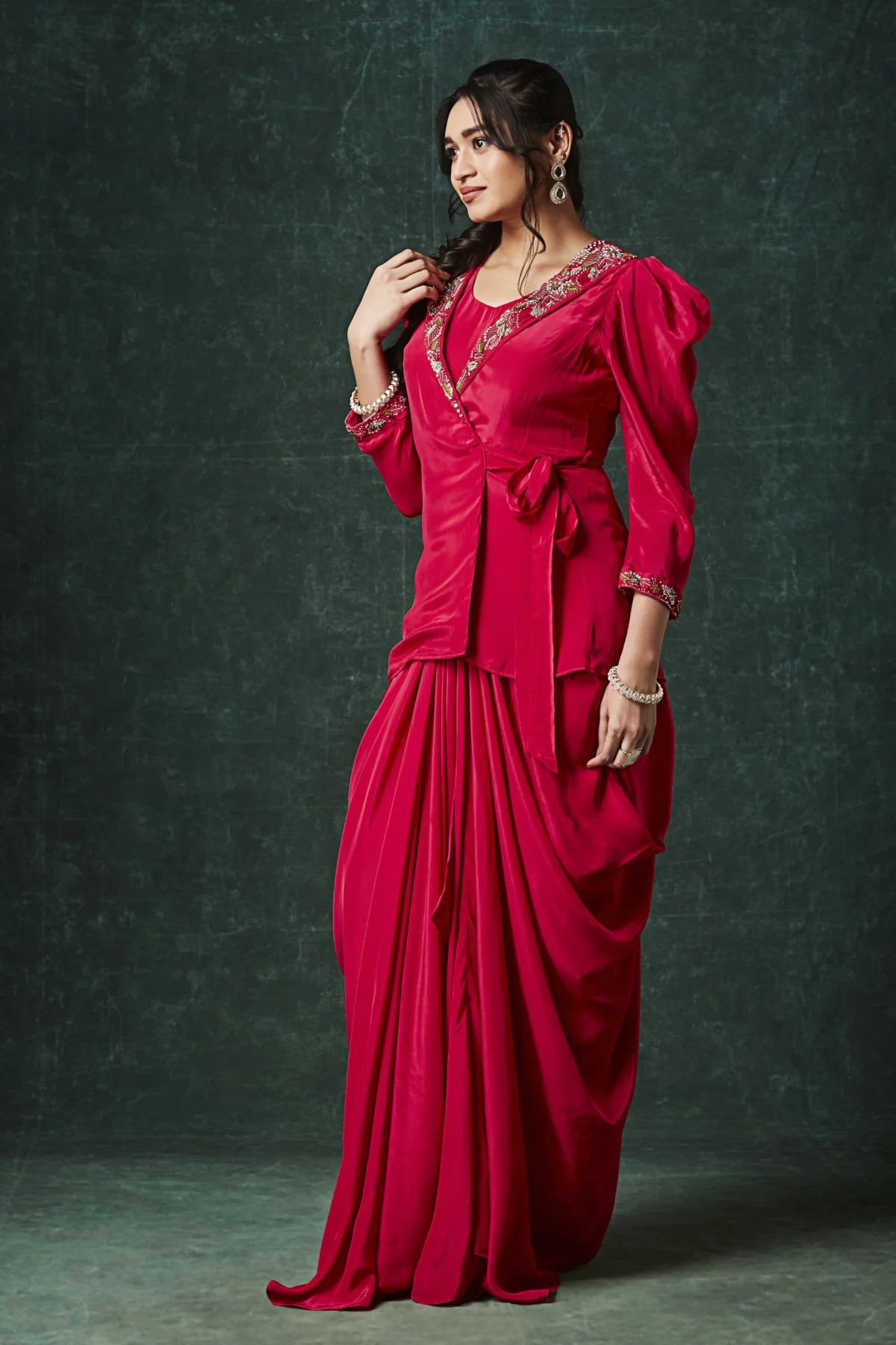 Red draped Indo Western outfit with embellished wrap blouse and pleated flowing skirt for wedding reception wear.