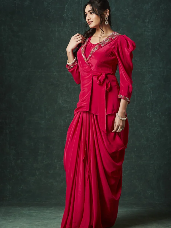 Red draped Indo Western outfit with embellished wrap blouse and pleated flowing skirt for wedding reception wear.