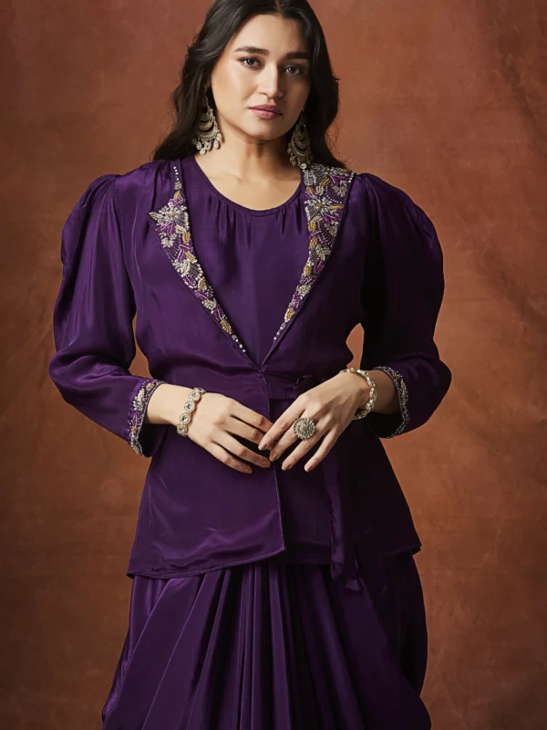 Purple draped Indo Western outfit with embellished wrap blouse and pleated flowing skirt for wedding reception wear.