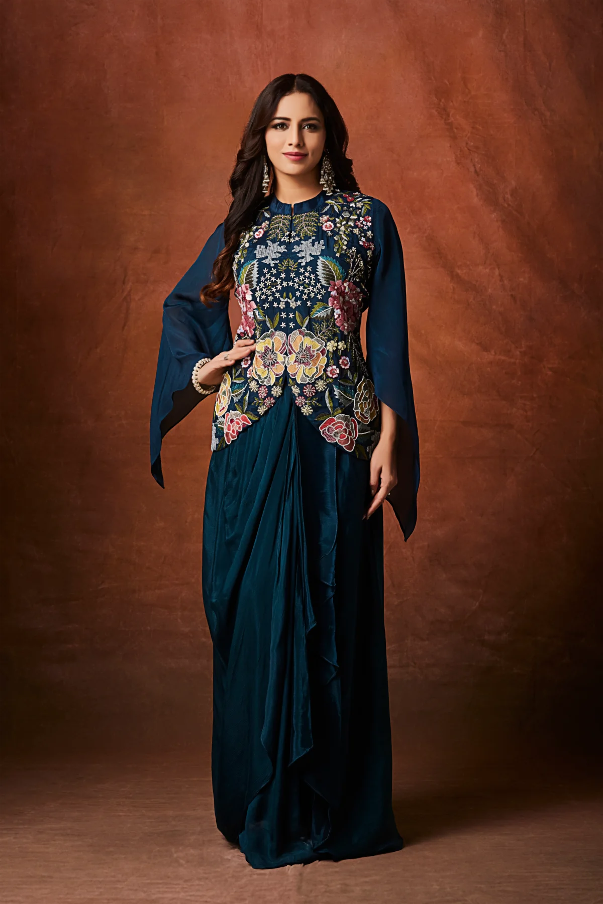 Midnight teal Indo Western drape set with floral embroidered bodice and cape sleeves for wedding and festive wear.