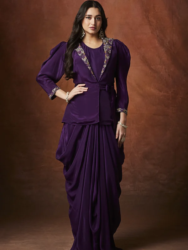 Purple draped Indo Western outfit with embellished wrap blouse and pleated flowing skirt for wedding reception wear.