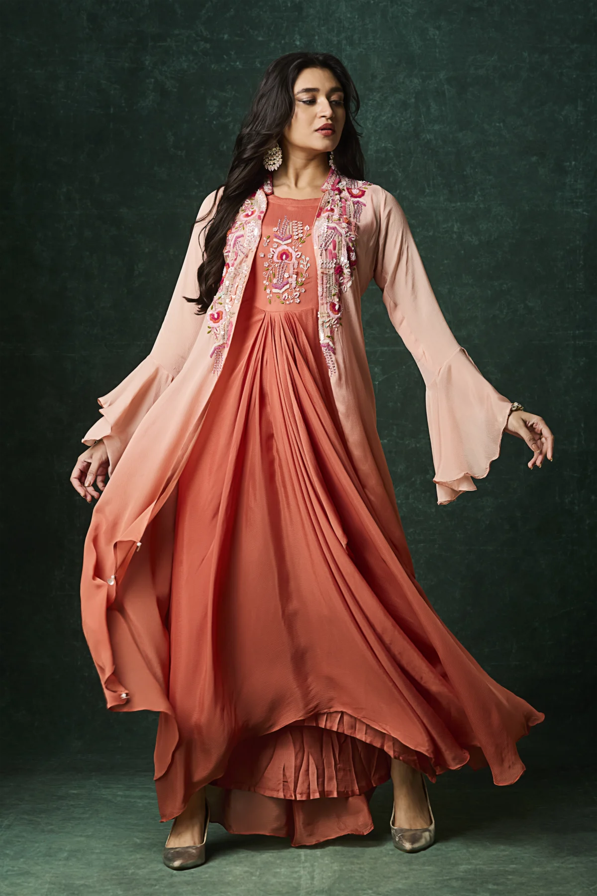 Peach layered Indo Western drape outfit with embroidered jacket and flared sleeves for wedding and festive wear