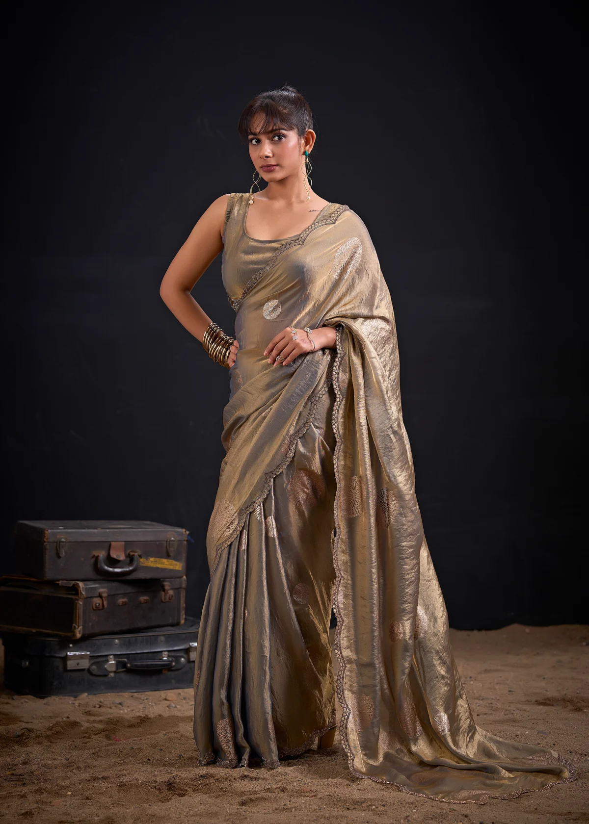 Celebrate every special moment in the Champagne Gold Shimmer Tissue Saree, crafted in premium shimmer tissue with elegant silver floral foil motifs that add timeless sophistication to every drape.