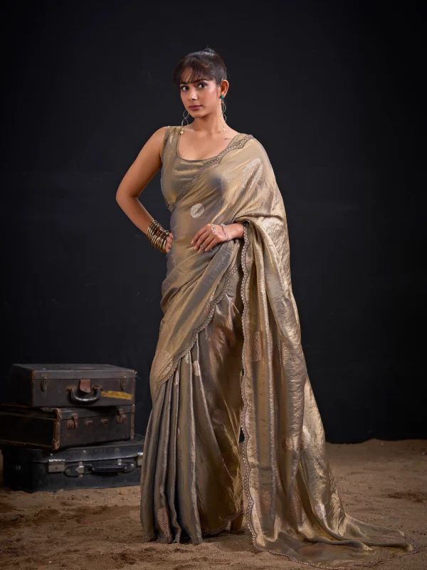 Celebrate every special moment in the Champagne Gold Shimmer Tissue Saree, crafted in premium shimmer tissue with elegant silver floral foil motifs that add timeless sophistication to every drape.