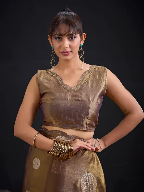 Celebrate every special moment in the Champagne Gold Shimmer Tissue Saree, crafted in premium shimmer tissue with elegant silver floral foil motifs that add timeless sophistication to every drape.