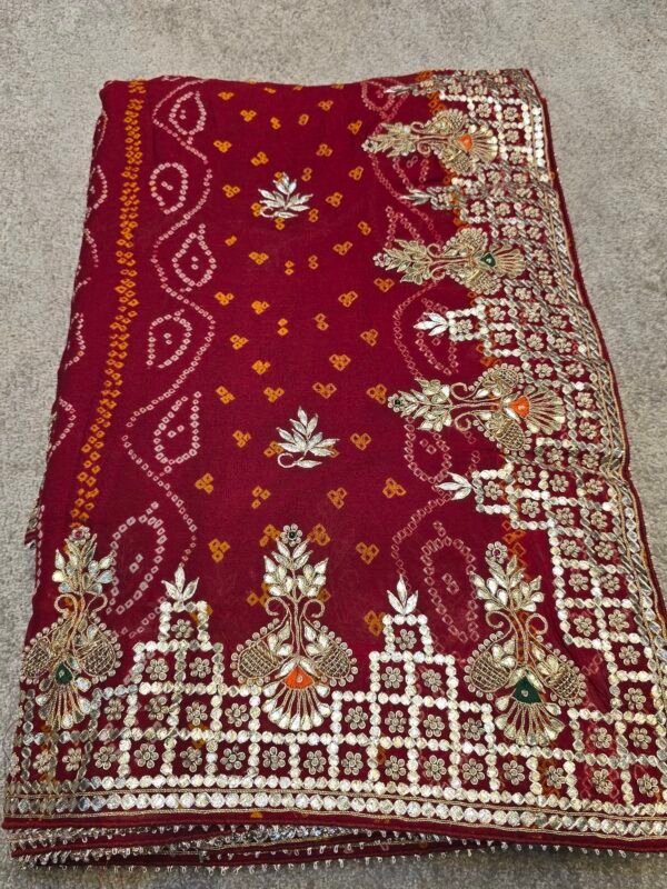 Pure Georgette Hand Bandhej Saree with Heavy Rajwadi Gota Patti Work in deep maroon, featuring traditional festive motifs, matching blouse piece, perfect for Teej, Raksha Bandhan, Karwa Chauth and wedding celebrations.