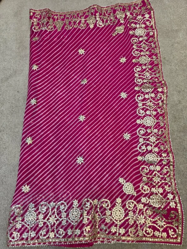 Rajsi Gulmohar Rani Pink Pure Georgette Lehariya Saree with handcrafted Silver Gota Patti embroidered floral border.