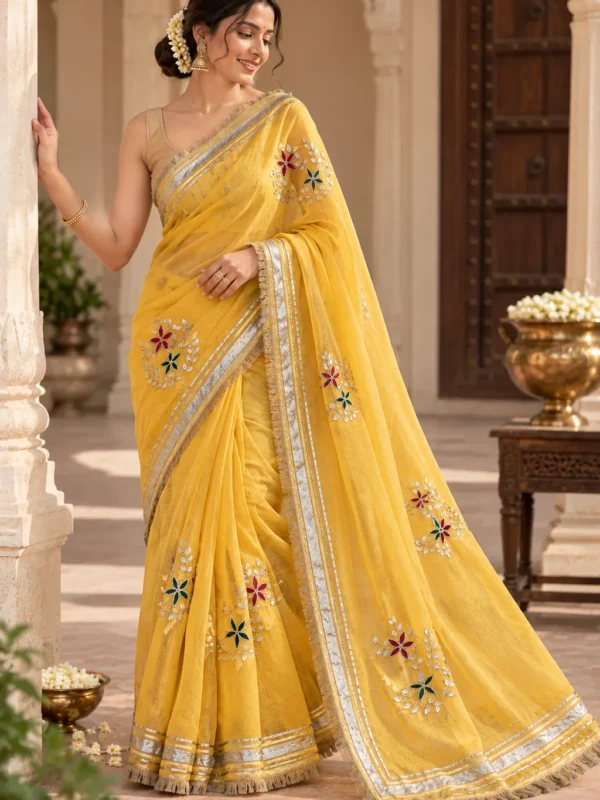 Yellow Kota Doria saree with Kaccha Gota work, floral embroidery, Lampi border and Sabyasachi lace styled on a woman